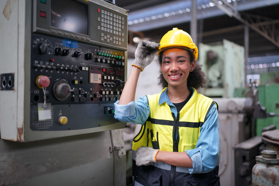 sustainable facility group female factory engineer with control panel